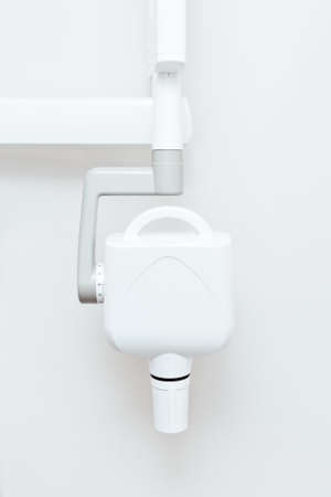 white dental x-ray machine on wall backgroundの写真素材
