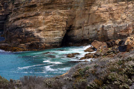 Close up rocks, cliff and cave at Maingon Bay, Tasmania, Australiaの写真素材
