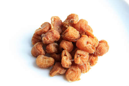 Chinese herb - Dried Longan isolated on whiteの写真素材