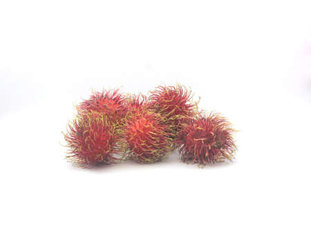 Five Asian red ripe rambutans on a white background.の写真素材