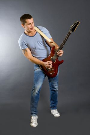 passionate guitarist playing his electric guitarの写真素材