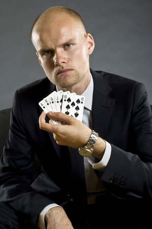 Poker player showing best hand in poker - royal flush