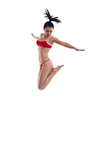 picture of a young attractive woman jumping over whiteの写真素材
