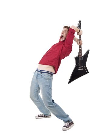 studio shot pictures on isolated background of a angry man holding a guitar and trying to brak itの写真素材