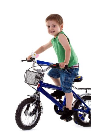 young boy riding a  bike over white backgroundの写真素材