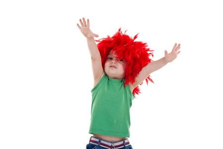 little party starter with hands up in the air - kid wearing a red feather wigの写真素材