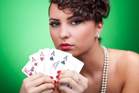 closeup of a sexy woman showing a good hand in poker - four acesのeditorial素材