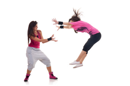 Two stylish female dancers making a breakdance move
