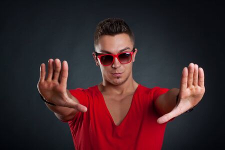 Handsome man making a stop sign with his hands, isolatedの写真素材