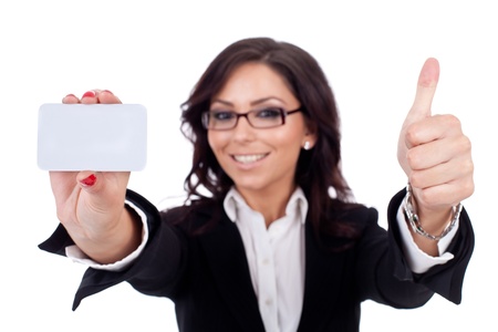 Portrait of young pretty woman holding blank business card giving thumbs up isolated on white backgroundの写真素材