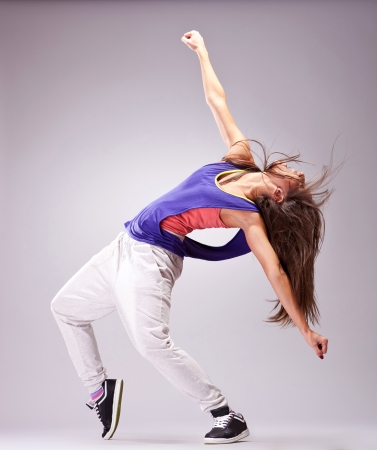 Beautiful woman dancer in hip hop attire striking a pose Beautiful woman dancer in hip hop attire striking a pose