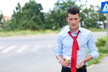 young business man having a break , drinking coffee and smoking a cigaretteの写真素材
