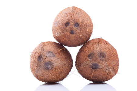 a group of three coconuts isolated on white