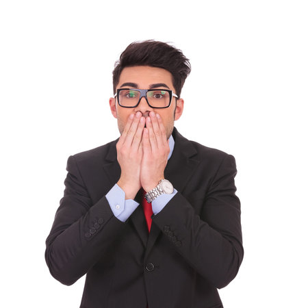 young business man covering his mouth over white backgroundの写真素材
