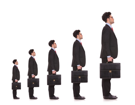 business man waiting in line for his career to evolve and to be a big bossの写真素材