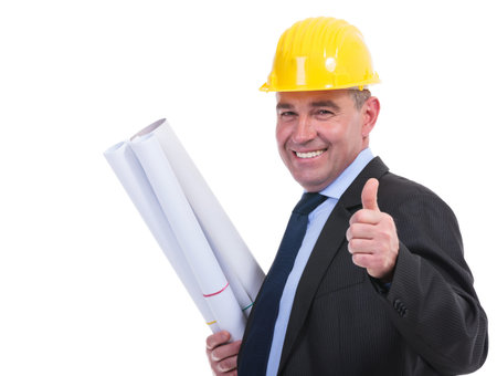 senior engineer holding some blueprints and showing thumb up while smiling to the camera. isolated...