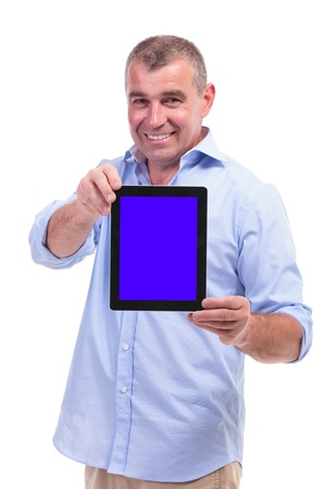 casual senior man showing you his tablet with a smile on his face. isolated on white backgroundの写真素材