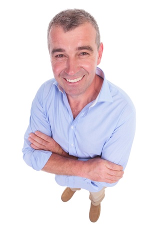 wide angle picture of a casual senior man  standing with his arms crossed and smiling for the camera. isolated on white backgroundの写真素材