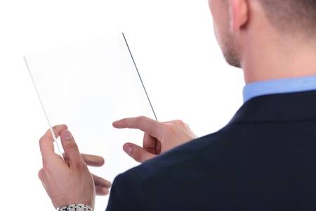 over the shoulder view of a young business man working on a futuristic transparent screen. on white backgroundの写真素材