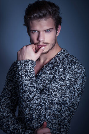 pensive beauty male model posing in studioの写真素材