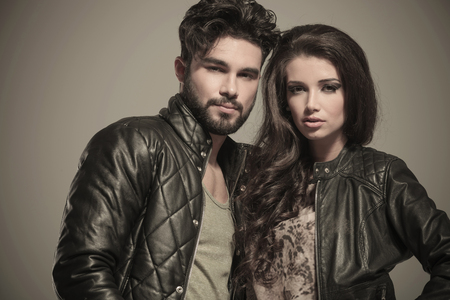 closeup picture of an embraced modern couple in leather jacketsの写真素材