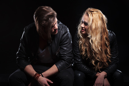 portrait of a seated young couple staring into each others eyes.の写真素材