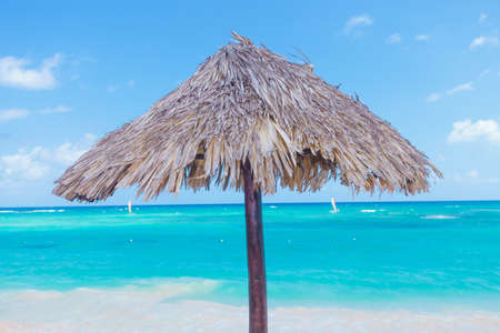 Wooden umbrella on the beautiful  punta cana beachの写真素材