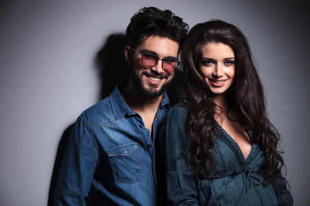 portrait of two lovers smiling to the camera in studioの写真素材