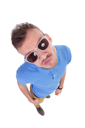 top view of a casual young man biting his lips. on a white backgroundの写真素材