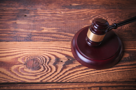 judge's gavel on old fir wood background, studio pictureの写真素材