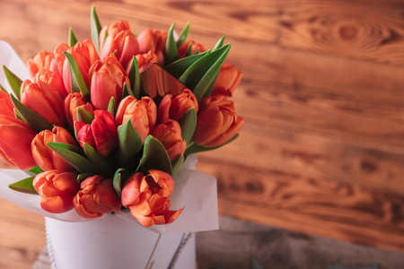 closeup picture of a tulips bouquet on wooden backgroundの写真素材