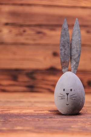 cute easter egg with rabbit ears and copyspace on old wood backgroundの写真素材