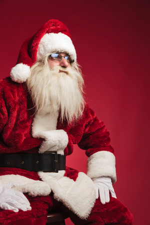 cutout side image of santa claus sitting on a chair looking away from the cameraの写真素材