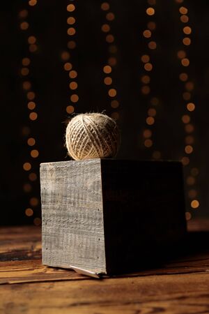 ball of thread placed on a wood on gray studio backgroundの写真素材