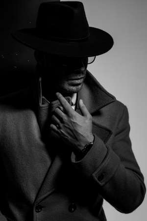 young businessman in suit covering face with big red heart and standing on pink backgroundの写真素材