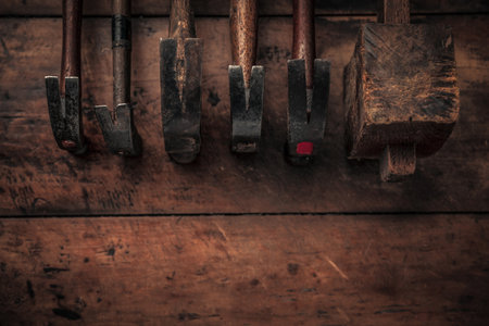 table view of set of vintage woodworking tools on a rough workbench with blank space below 
carpentry, craftsmanship and handwork conceptの写真素材