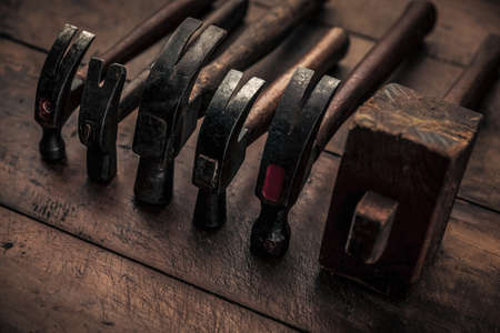 collection of carpentry hammers on top of old vintage workbench for manual workの写真素材
