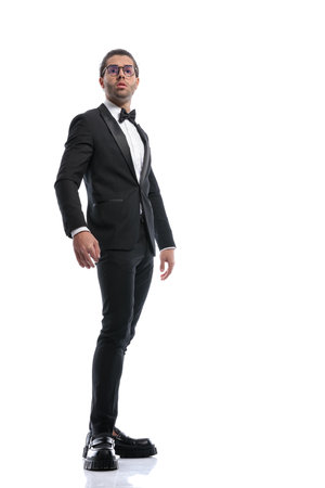 elegant businessman posing with a sense of pride and wearing glasses against white studio backgroundの写真素材