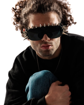 sexy curly hair guy with glasses crouching and posing in a cool way in front of white backgroundの写真素材