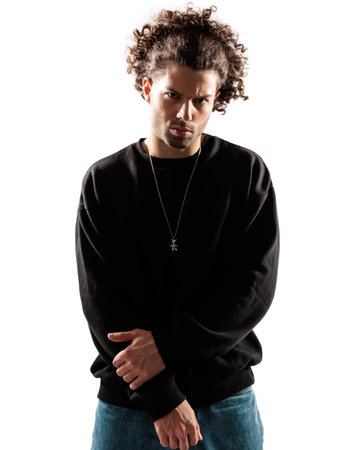 sexy young man with curly hair in black sweatshirt posing in a cool way in front of white backgroundの写真素材