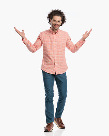 full body picture of handsome happy guy with glasses opening arms, smiling and walking on white backgroundの写真素材