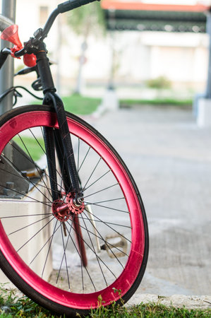 Black bicycle has red wheel