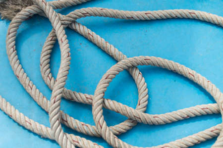 rope binds a boat and blue backgroundの写真素材