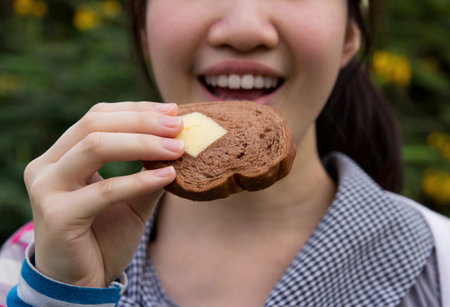Woman eating bread.