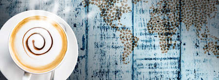 Coffee cup and saucer on vintage wood background の写真素材