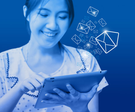 Happy woman sending email