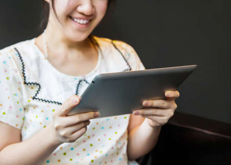 Happy woman using tablet pcの写真素材