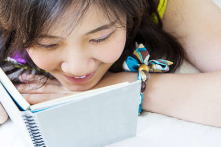 Asian woman reading bookletの写真素材