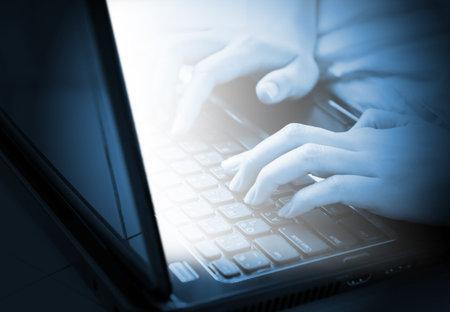 Woman hands typing on laptop keyboard
