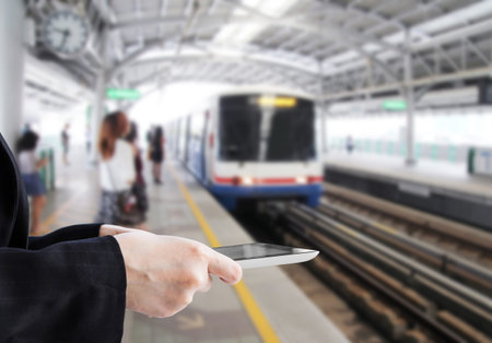 Businesswoman using digital tablet in skytrain station